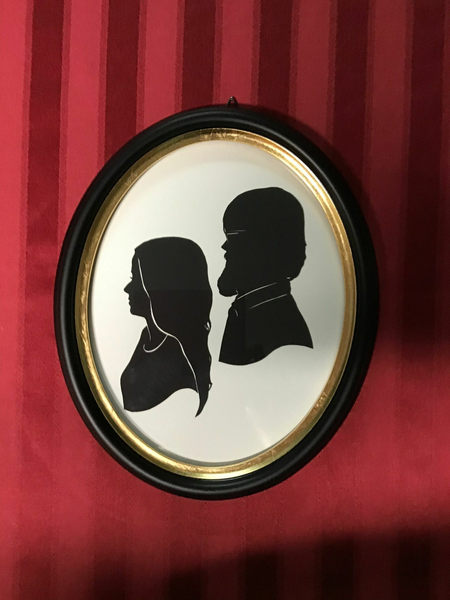 Two Original Silhouettes, Mounted in Large Oval Frame